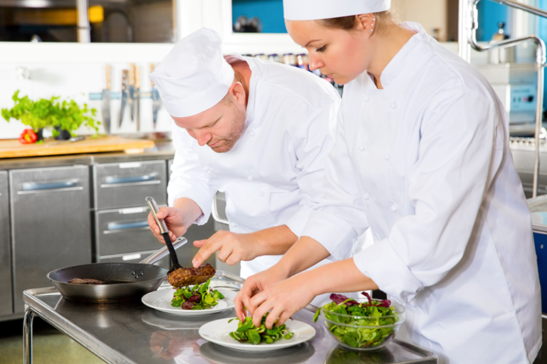 Two-chefs-prepares-steak-dish-at-gourmet-restaurant-training-loss-prevention