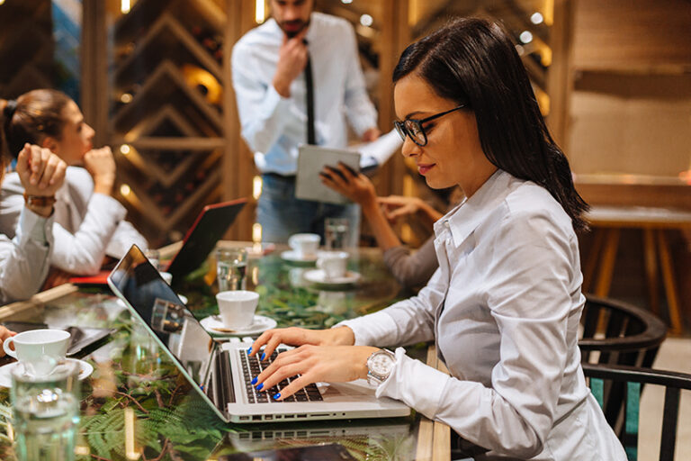 Young business woman working on laptop desk at a business meeting